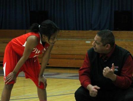 Uniqua Mitchell talks with head coach Mike Llanas during a free throw attempt for Lakeland. She scored a team-high 18 points in the win. Photo by Nicholas Huenefeld/Owens Sports Information